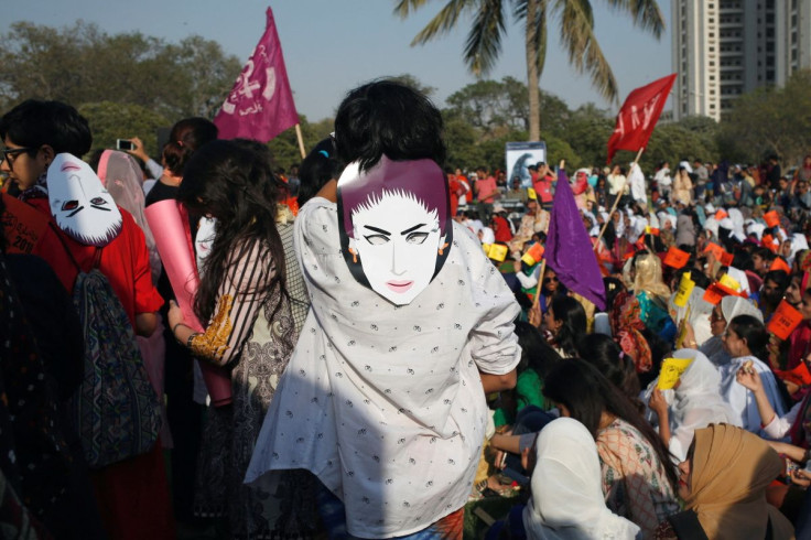 Protesters wear masks depicting Qandeel Baloch, a Pakistani social media celebrity who according to police was strangled in what appeared to be an "honour killing" in 2016, in Karachi, Pakistan, March 8, 2018. 