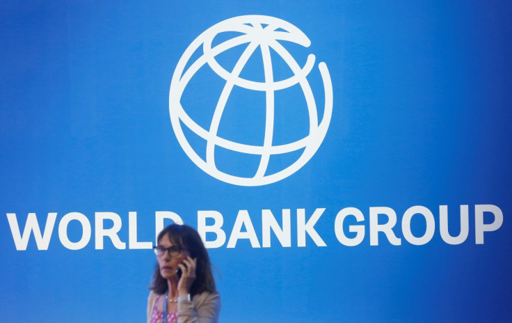 A participant stands near a logo of World Bank at the International Monetary Fund - World Bank Annual Meeting 2018 in Nusa Dua, Bali, Indonesia, October 12, 2018. 