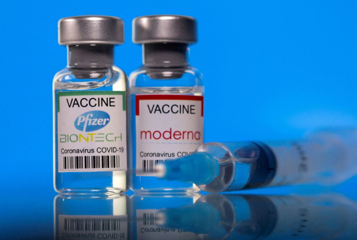 Vials with Pfizer-BioNTech and Moderna coronavirus disease (COVID-19) vaccine labels are seen in this illustration picture taken March 19, 2021. 