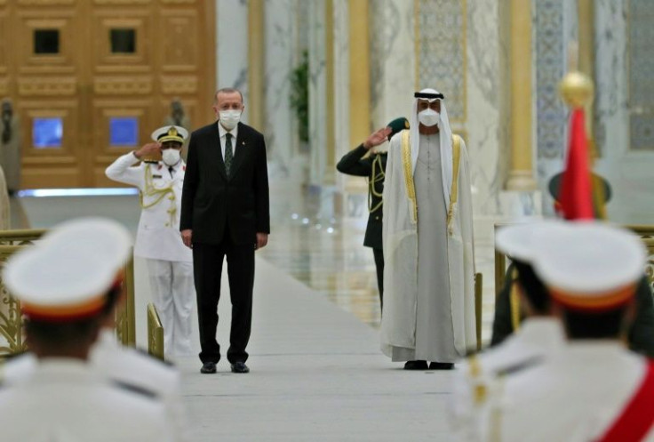 Turkish President Recep Tayyip Erdogan, on the left, is  welcomed by Crown Prince of Abu Dhabi, Sheikh Mohammed bin Zayed Al-Nahyan, in the UAE capital
