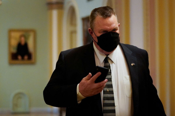 U.S. Senator Jon Tester (D-MT) walks through a hallway as the Senate continues debate of voting rights legislation at the U.S. Capitol in Washington, U.S., January 19, 2022. 