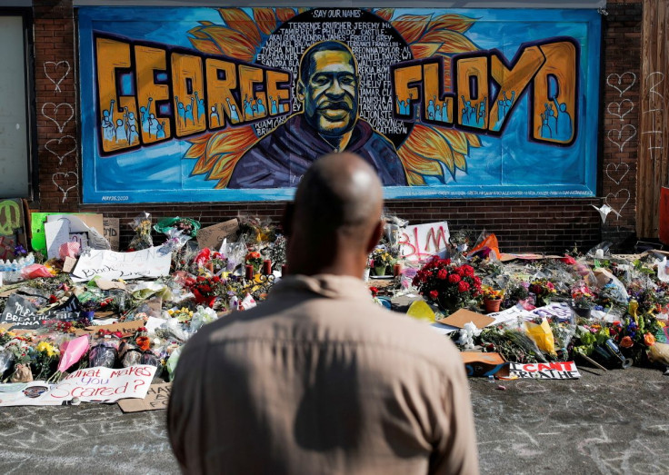 A local resident stands in front of a makeshift memorial honoring George Floyd, at the spot where he was taken into custody, in Minneapolis, Minnesota, U.S., June 1, 2020.  
