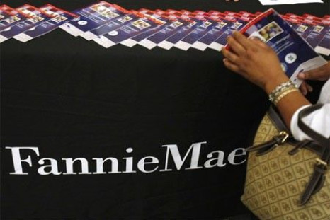 A woman takes a brochure detailing how homeowners can make their mortgage payments more affordable at the Fannie Mae booth.