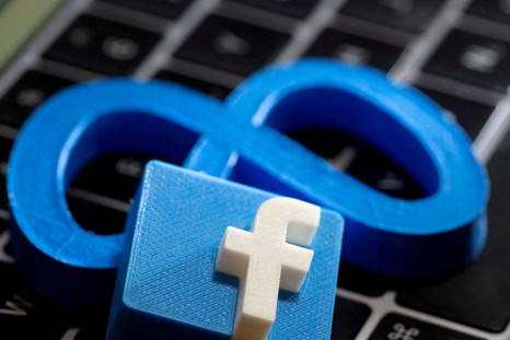 3D-printed images of logos of Facebook parent Meta Platforms and of Facebook are seen on a laptop keyboard in this illustration taken on November 2, 2021. 
