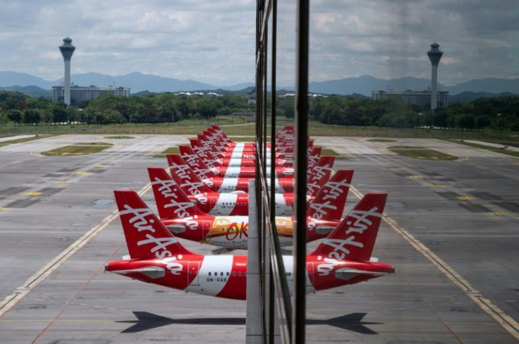 An AirAsia jet was forced to divert and make an unscheduled landing after a snake was spotted slithering through the overhead lights
