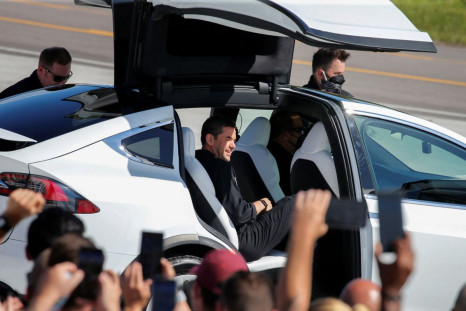 Jared Isaacman, founder and CEO of Shift4 Payments and flight commander, climbs into a Tesla as the Inspiration 4 crew, the first all-civilian crew to be sent into orbit, gather before dawning space suits to head to the SpaceX Falcon 9 rocket on Pad 39A a