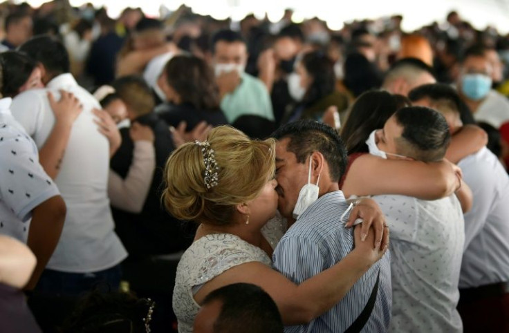 Couples kiss at a collective wedding on Valentine's Day in Ciudad Nezahualcoyotl, a suburb of Mexico City