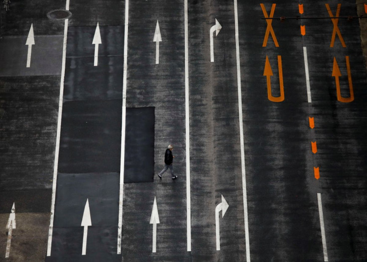 A man walks on an empty road, amid the coronavirus disease (COVID-19) pandemic, in Tokyo, Japan December 8, 2021. 