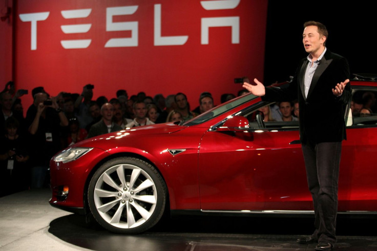 Tesla Motors CEO Elon Musk speaks next to the company's newest Model S during the Model S Beta Event held at the Tesla factory in Fremont, California October 1, 2011.   