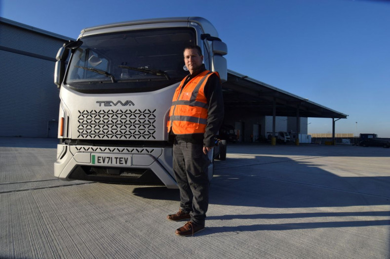 Asher Bennett, CEO of electric truck maker Tevva, poses for a photo in front of a pre-production prototype truck at the startup's UK plant, in Tilbury, Britain, January 14, 2022. 
