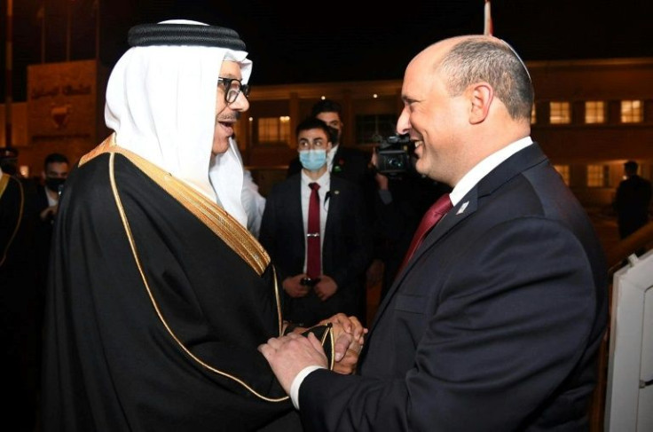 Israeli Prime Minister Naftali Bennett (R) was greeted by Bahrain's Foreign Minister Abdullatif bin Rashid Al-Zayani late on Monday