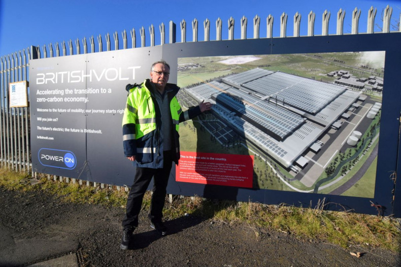 Peter Rolton, executive chairman of electric vehicle battery startup Britishvolt, shows a billboard at the site of the company's large planned battery plant, in the former industrial town of Blyth, Britain January 27, 2022. 