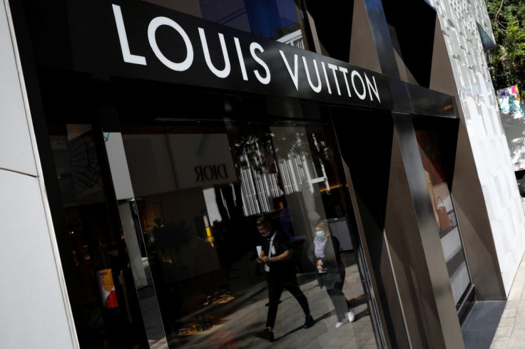 People walk past the Louis Vuitton store at Miami Design District, in Miami, Florida, U.S. November 30, 2021.