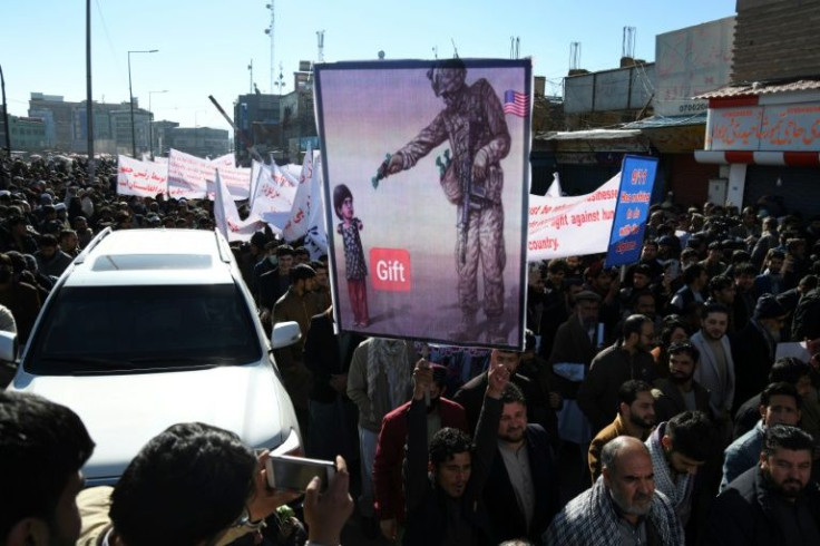 People march in Kabul against plans by President Joe Biden to freeze Afghan assets held in the United States
