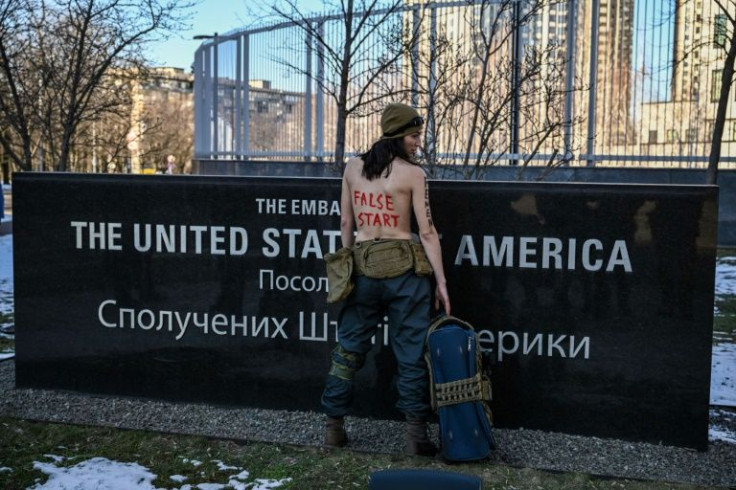 Some Ukrainians, such as a bare-chested Femen activist, have mocked the US decision to withdraw its embassy from the capital Kyiv
