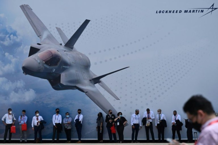 Singapore Airshow visitors stand next to a display for Lockheed Martin, one of only a handful of major arms suppliers left, according to a new US Department of Defense report