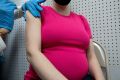 A pregnant woman receives a vaccine for the coronavirus disease (COVID-19) at Skippack Pharmacy in Schwenksville, Pennsylvania, U.S., February 11, 2021.  