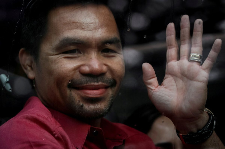Philippine senator and newly retired boxing icon Manny Pacquiao waves to supporters as he files his certificate of candidacy for president, in Pasay City, Metro Manila, Philippines, October 1, 2021.