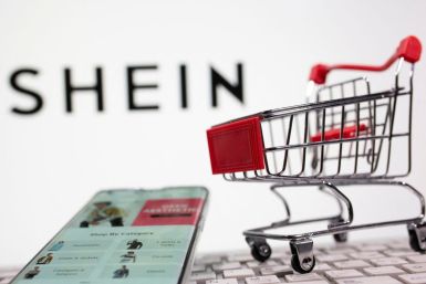 A keyboard and a shopping cart are seen in front of a displayed Shein logo in this illustration picture taken October 13, 2020. 