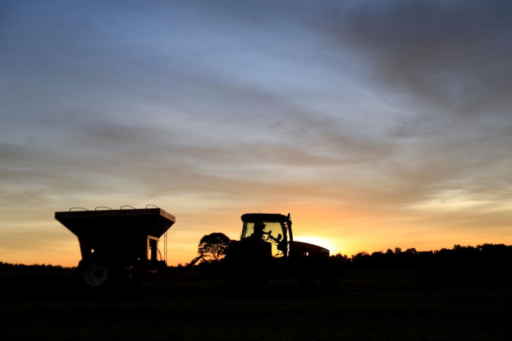 FILE PHOTO - A tractor is silhouetted after harvesting soybeans at a farm in Caaguazu, Paraguay February 17, 2020. Picture taken February 17, 2020.