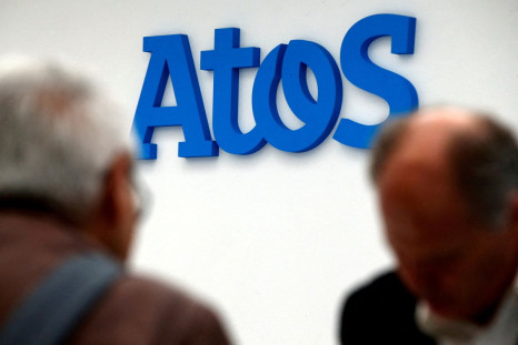 People walk in front of the Atos company's logo in Paris, France, April 12, 2016. 