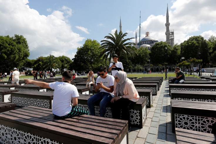 Foreign tourists pause at Sultanahmet Square as they visit the Old City in Istanbul, Turkey July 8, 2021.