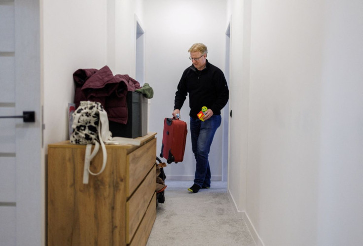Daniel Williams from Britain carries a bag at his home in Kyiv, Ukraine, February 15, 2022.