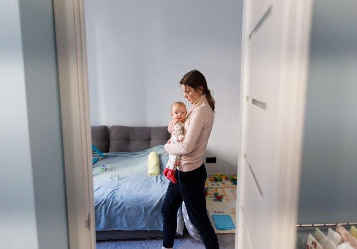 A nanny holds Tanya and Daniel's child at their home in Kyiv, Ukraine, February 15, 2022.  