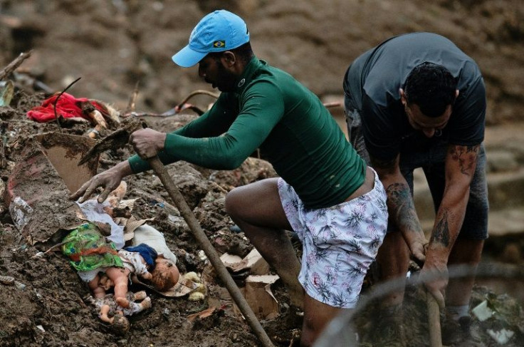 People lift rubble to look for survivors in a mudslide in Petropolis, Brazil on February 16, 2022