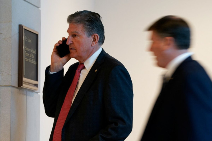 U.S. Senator Joe Manchin (D-WV) speaks on his phone in a hallway on Capitol Hill in Washington, D.C., U.S., February 3, 2022. 