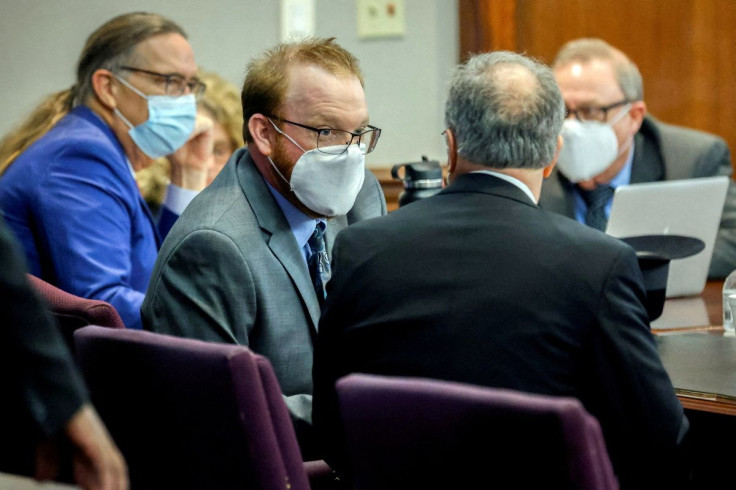 Travis McMichael, left, speaks with his attorney Bob Rubin, right, during the sentencing of his and his father Greg McMichael and neighbor, William "Roddie" Bryan, Friday, Jan. 7, 2022, in the Glynn County Courthouse, Brunswick, Ga. U.S., Friday, January