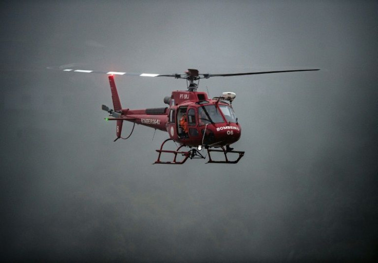 A fire brigade helicopter surveys an area hit by torrential rains and floods in Petropolis, Brazil February 16, 2022