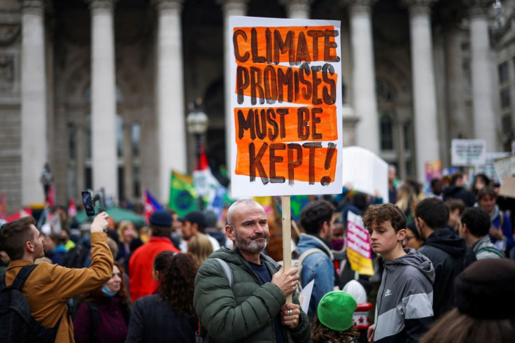 A demonstrator holds a banner during a protest outside the Bank of England, as the UN Climate Change Conference (COP26) takes place, in London, Britain, November 6, 2021. 