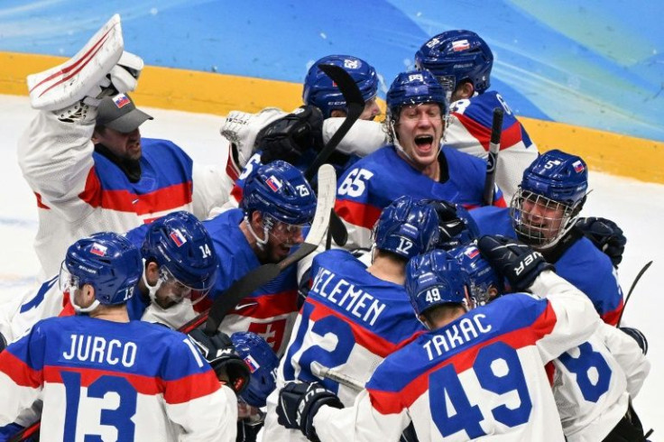 Slovakia's players celebrate victory over the USA in the men's ice hockey competition at the Beijing Olympics