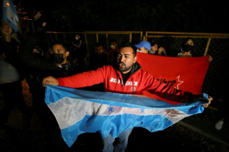Dozens of Hondurans celebrated outside former president Juan Orlando Hernandez's home in Tegucigalpa