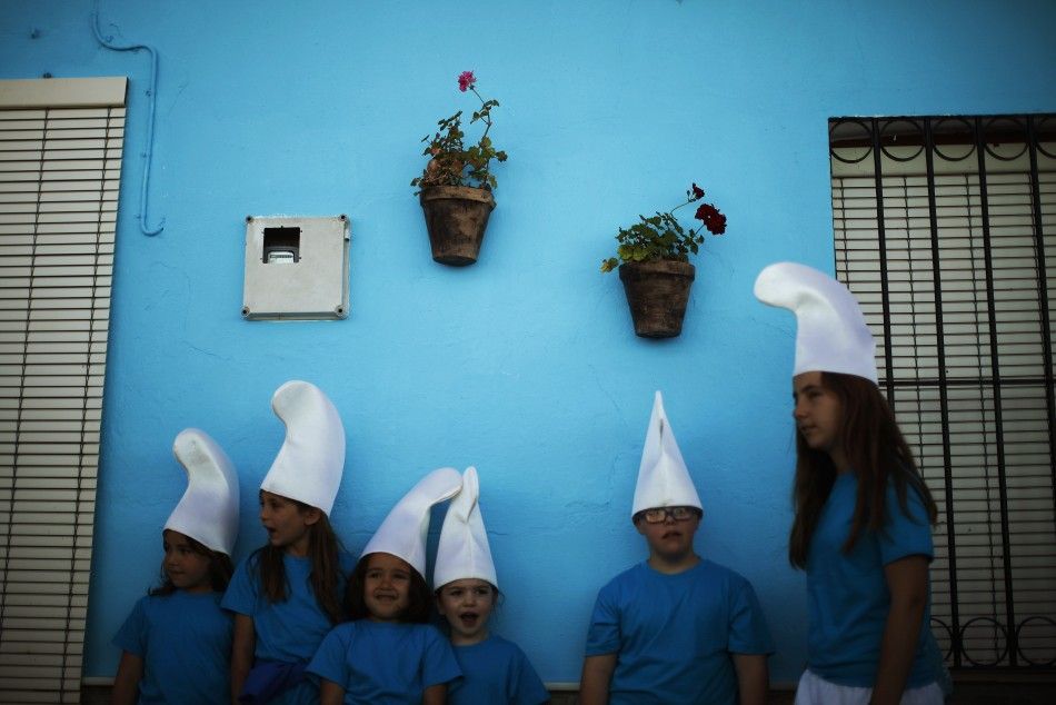 Children dressed up as smurfs take part in a promotional event in the Andalusian village of Juzcar