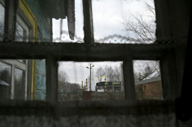 Ukrainian pensioner Lidiya Silina can see the Ukrainian flag fly over the Belarusian border from her rear window