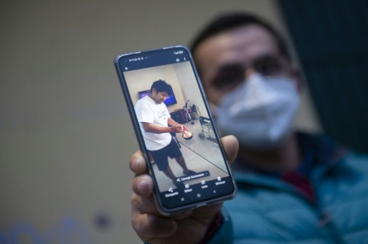 Peruvian fisherman Jonathan Calderon, pictured on the phone, had been a member of the Villa de Pitanxo crew for 12 years