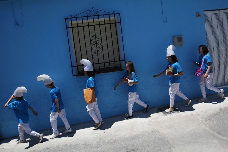 Children dressed up as smurfs take part in a promotional event in the Andalusian village of Juzcar