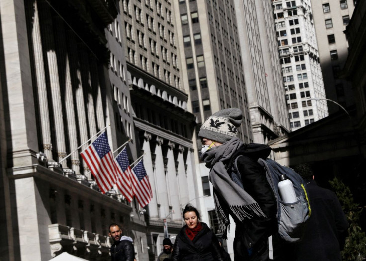 A woman wears a mask near the New York Stock Exchange (NYSE) in the Financial District in New York, U.S., March 4, 2020.