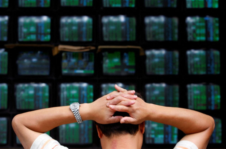 A man looks at stock market monitors in Taiwan