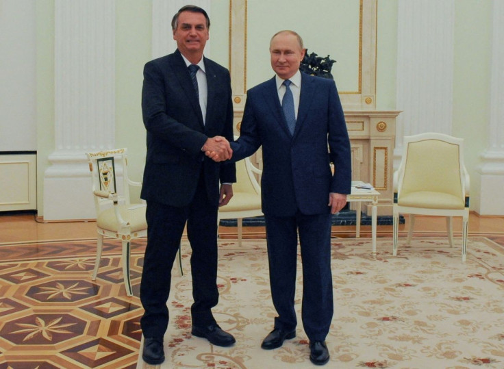 Russian President Vladimir Putin shakes hands with his Brazilian counterpart Jair Bolsonaro during a meeting in Moscow, Russia February 16, 2022. Sputnik/Mikhail Klimentyev/Kremlin via REUTERS 