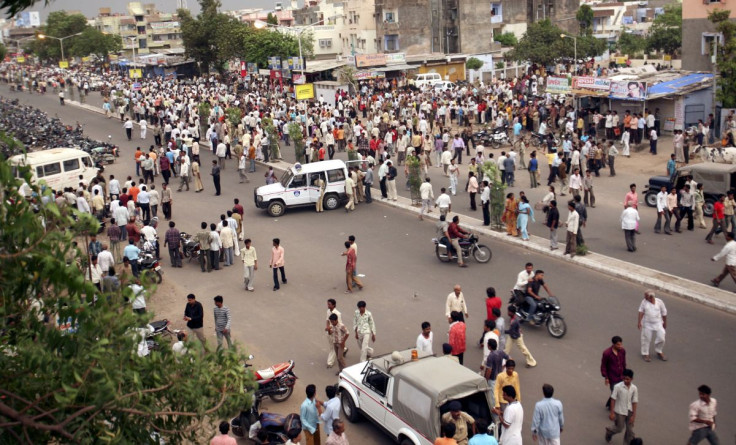 People crowd on a road after a series of bombings in the western Indian city of Ahmedabad July 26, 2008.
