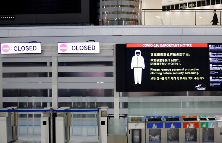 A notice about COVID-19 safety measures is pictured next to closed doors at a departure hall of Narita international airport on the first day of closed borders to prevent the spread of the new coronavirus Omicron variant in Narita, east of Tokyo, Japan, N