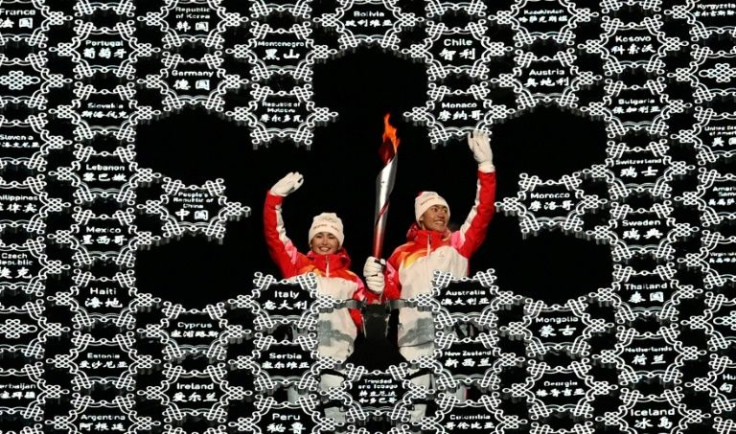Ethnic Uyghur skier Dinigeer Yilamujian (L) was chosen by China to help light the Olympic cauldron