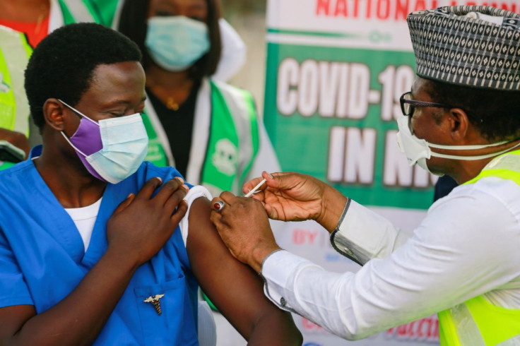Dr Ngong Cyprian receives his first dose of the Oxford/AstraZeneca coronavirus disease (COVID-19) vaccine from Dr Faisal Shuaib, Executive Director and Chief Executive Officer of the National Primary Health Care Development Agency, at the National hospita