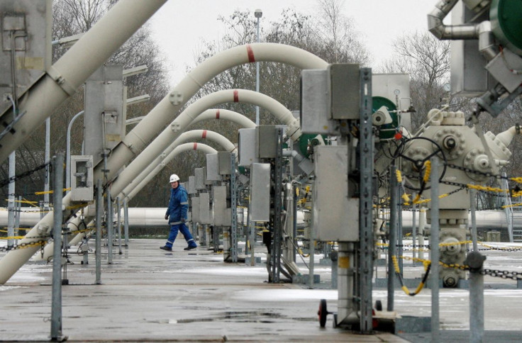 A technician walks between flow lines at the WINGAS gas storage facility near the northern German town of Rehden, January 7, 2009. 