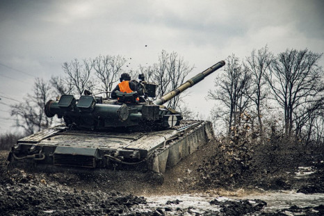 A service member of the Ukrainian Naval Infantry Corps (Marine Corps) drives a tank during drills at a training ground in an unknown location in Ukraine, in this handout picture released February 18, 2022. Press Service of the Ukrainian Naval Forces/Hando