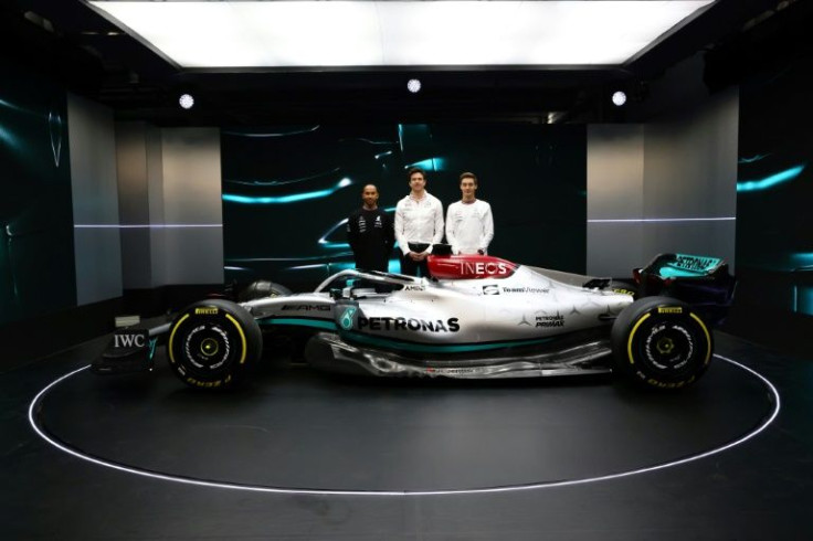 Mercedes drivers Lewis Hamilton (left) and George Russell (right) pose alongside Mercedes chief Toto Wolff