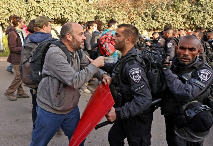 A protester argues with an Israeli policeman in Sheikh Jarrah